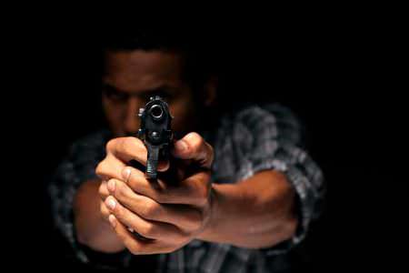 Robber Revolver Gun Barrel Robbery Man armed man finger on trigger warning iStock-VladimirFLoyd 477901851