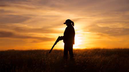 woman upland game hunter shotgun sunset 133958720 Shutterstock