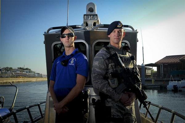 Air Force Senior Airmen Zade Becker, left, a marine patrolman assigned to the 6th Security Forces Squadron, and his brother Austin Becker, right, an emergency services team operator assigned to the 6th SFS, pose for a photo at MacDill Air Force Base, Fla., Dec. 14, 2016. The Becker brothers are currently stationed together at MacDill and defend the base as security forces members. Air Force photo by Airman 1st Class Mariette Adams