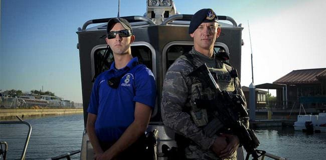 Air Force Senior Airmen Zade Becker, left, a marine patrolman assigned to the 6th Security Forces Squadron, and his brother Austin Becker, right, an emergency services team operator assigned to the 6th SFS, pose for a photo at MacDill Air Force Base, Fla., Dec. 14, 2016. The Becker brothers are currently stationed together at MacDill and defend the base as security forces members. Air Force photo by Airman 1st Class Mariette Adams