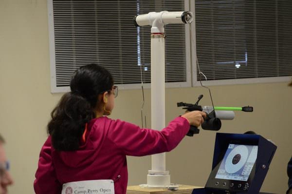 Because of her size, Emma used a weighted sling to fire her air pistol during the match.