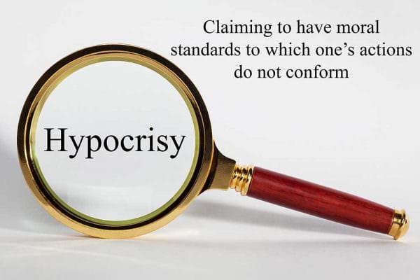 Hypocrisy Hypocrite Ethics Concept looking at Ethics through a magnifying glass shutterstock_travellight 153359564