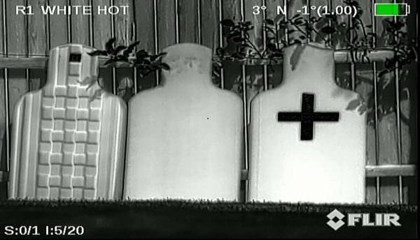 (L-R) Military E-Target with self-adhesive foil aiming point, a typical cardboard silhouette, a cardboard silhouette with a self-adhesive foil tape target.