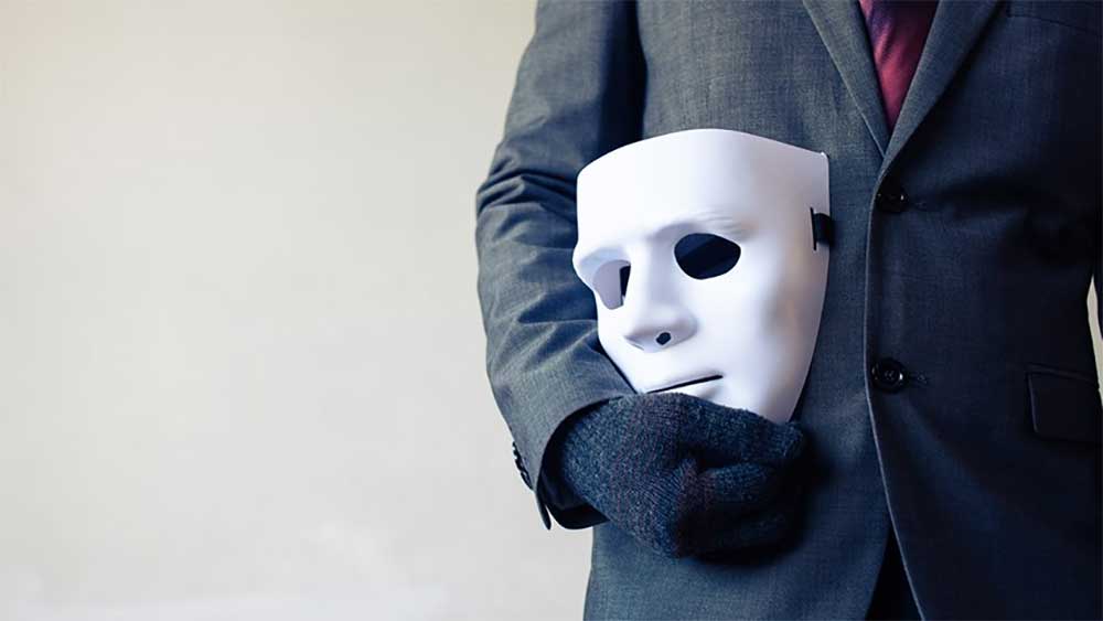 Mask Hidden Agenda Gun Banners Businessman carrying white mask iStock-twinsterphoto 624010374