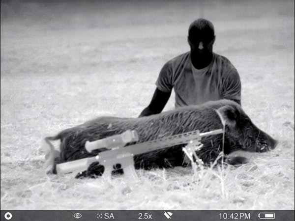 James "The Texecutioner" Vick poses with his boar for a cool thermal photo! The image was taken with a Pulsar Helion XP50 Thermal Monocular. 