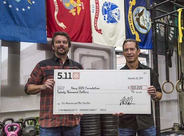 Driessen and 5.11 CEO, Tom Davin, holding the $20,000 check for Navy SEAL Foundation