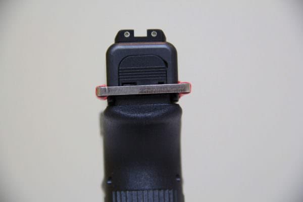 To install the Glock E-Trainer lock the slide back to the rear and insert the device onto the underside of the back of the slide.