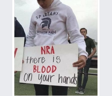 Student Holds Anti-NRA Sign in ΜΟΛΩΝ ΛΑΒΕ Hoodie