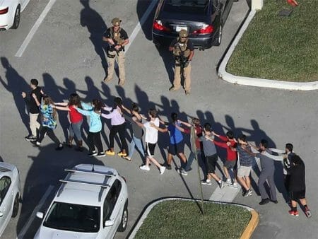 Students are brought out of the Marjory Stoneman Douglas High School after a shooting at the school