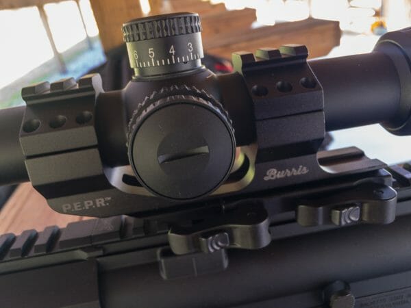 The Burris P.E.P.R. scope mount is cantilevered for MSR use and features quick detach levers. Notice the rail segments on top for red dot mounting. A smooth set of top rings is also included.