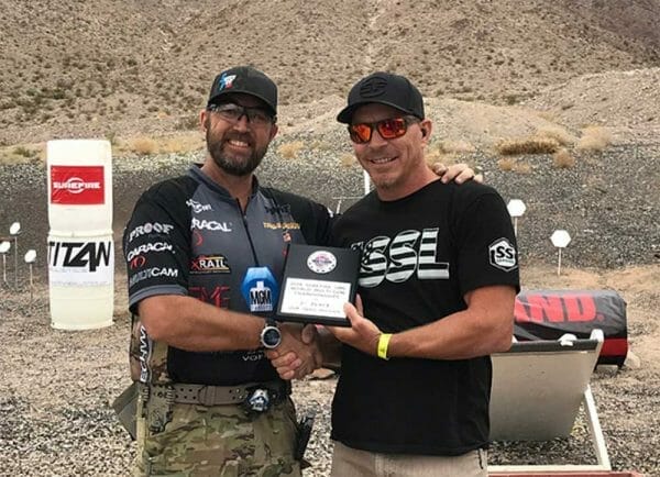 Gibson (L) finished second overall in the 2x4 Open Division, posting top-three finishes in nine of the competition’s stages (Match Director, Pete Rensing at right).