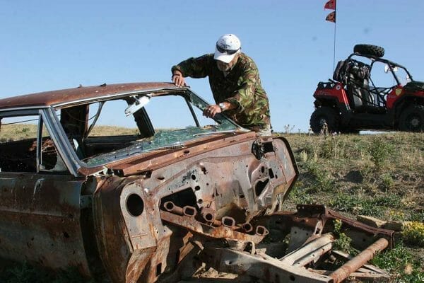 Author setting up for a junk car shoot at long range via the Nikon Black FX1000 Riflescope Reticle, And the Ruger 300 Win Mag "Long Range" rifl