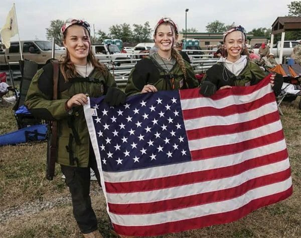 Victoria Wheatley, Amy Flood, and Shelby Falk proudly hold up the American flag. Photo courtesy of Steven Falk