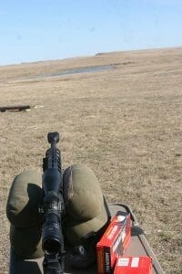 Testing 800 yard down range on junk cars across a small lake.