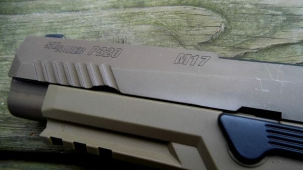 The civilian gun features black controls as opposed to tan on the military model. There are also minor differences in the engraving and the type of anti-corrosion finishes used.