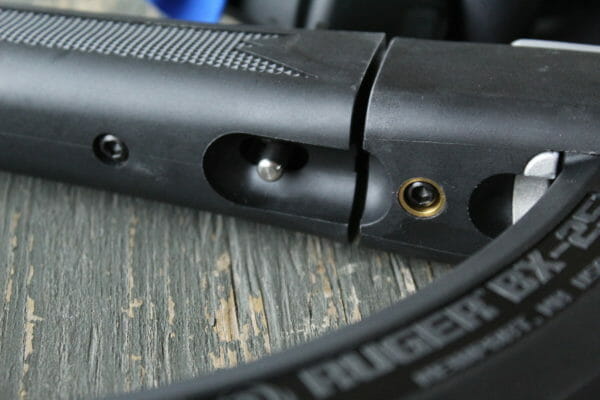 The recessed takedown lever is pulled back, allowing both halves of the gun to fit together. When taking the gun apart, you may have to retract the charging handle a touch.