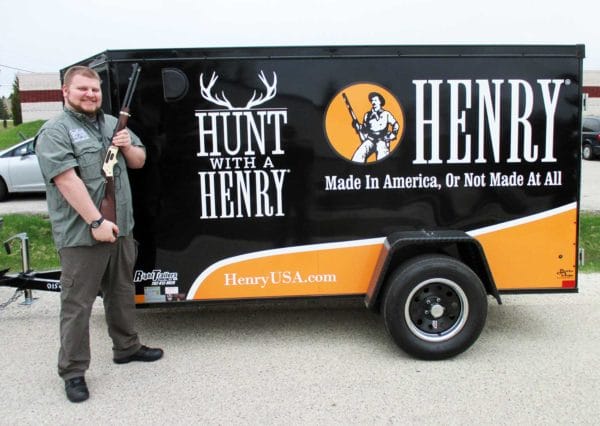 Joe Bullock a sales associate at The Shooters Sports Center in Racine Wisconsin with a new Henry Model 24 lever action, side loading gate rifle.