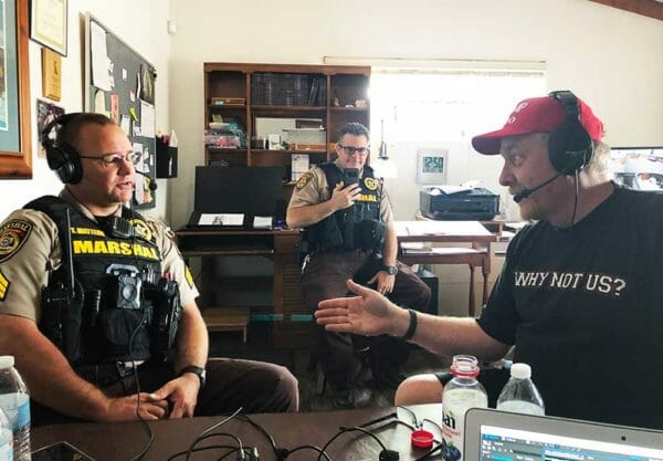 Mark and Curt Schilling interviewing Tombstone Marshal Seargent Travis Mattern on Armed American Radio w/ Tombstone Deputy Dave Neuss filming in the background