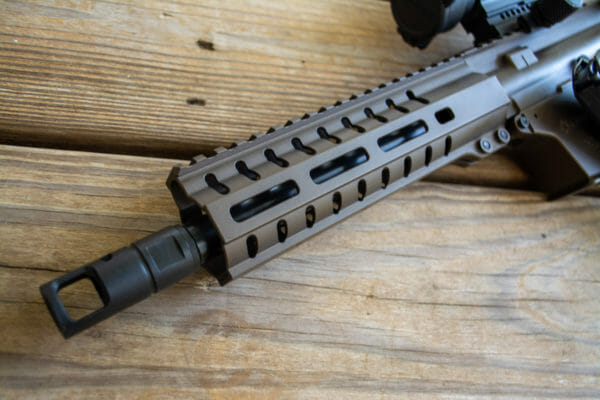 The upper receiver has a full-length top rail and M-LOK attachment points.
