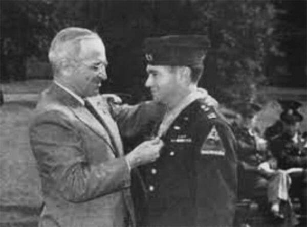 President Harry S. Truman places the Medal of Honor around the neck of Army Capt. James Burt during a White House ceremony, Oct. 12, 1945. Army Capt. James Burt Awarded the Medal of Honor