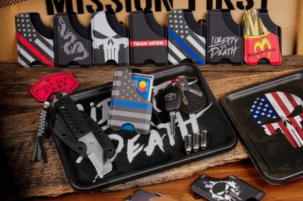 Mission First Tactical (MFT) Introduces New Decorated Wallets and Dump TraysHorsham, Pa. (Ammoland.com) – Mission First Tactical, LLC (MFT™), a leader in USA-made rifle/carbine accessories, is proud to announce its Wallets and Dump Trays have been added to its new Decorated Products line up. Designs are chemically bonded to MFT’s Wallets and Dump Trays to ensure wear, scratch and chemical resistance. Express yourself with MFT offerings or let MFT place your unique image on any of our wallets, dump trays, magazines and more. Every week, MFT will be offering a limited-edition design as a giveaway and a limited-edition sale only available through its social media channels. Follow and like MFT’s Instagram, Facebook, and Twitter platforms to find out about each week’s giveaway and sale.Securely store and easily access credit cards or business cards with MFT’s Decorated Wallets. Handcrafted from Boltaron material in the United States of America, MFT Wallets are available in either an eight-credit card (15 business cards) or 15 credit card (25 business cards) wallet configuration. MFT image offerings include American Flag M1; Blue Line American Flag 1, Flag 2 or Flag 3; American Flag Vintage; Redline American Flag; Betsy Ross Flag; MFT Freedom Fries; Gadsden Flag; Join or Die; Liberty or Death; Punisher Skull Splatter White; Punisher Skull Oversize; or Team MF’ER Supreme. MSRP $24.99.MFT’s Dump Tray provides a convenient place to drop all your everyday carry (EDC) items when you walk in the door or sit down at your desk. The small compartment is designed for your phone or small items with a larger area for everything else. The Dump Tray measures 8.2” x 11.2” with the small area measuring 3.5” x 7” and the large area measuring 6” x 7.” Handcrafted from Boltaron Material in the United States of America, the Dump Trays are available in the following MFT image offerings: American Flag M1 or M2; American Flag Punisher Skull; American Flag Punisher Skull MultiCam; Blue Line American Flag 1, Flag 2 or Flag 3; Redline American Flag; Betsy Ross Flag; Gadsden Flag; Join or Die; Join or Die MultiCam; Liberty or Death; Liberty or Death MultiCam; Punisher Skull Splatter White; or Team MF’ER Supreme. MSRP $39.99.For more information on Mission First Tactical, visit www.missionfirsttactical.com.About Mission First Tactical:Mission First TacticalMission First Tactical (MFT) designs and develops select USA Made rifle/carbine accessories and Kydex-style, Boltaron material holsters handmade by Veterans specifically for the Military, Law Enforcement, and Civilian markets. The MFT team has over 75 years of industry experience in taking concepts to front-line deployment. From the beginning, MFT’s mission is to develop leading-edge products for individuals operating in harm’s way. Success for every operator’s mission is Mission First Tactical’s intent. www.missionfirsttactical.com