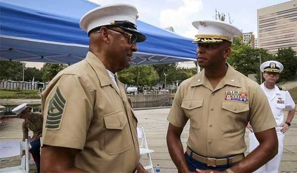 Medal of Honor Recipient Sgt. Maj. John L. Canley talks with a young Marine