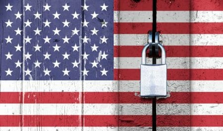 USA flag wooden door locked padlock border wall immigration IMG iStock/fermate 641331942