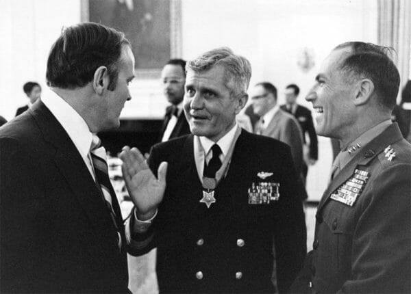 Medal of Honor recipient Rear Adm. James B. Stockdale, center, chats with guests, including Lt. Gen. Samuel J. Jaskilka, assistant commandant of the U. S. Marine Corps, right, following his award ceremony at the White House, March 4, 1976.