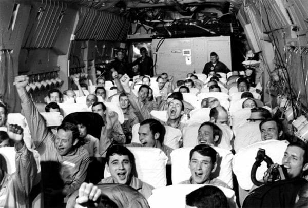 Newly freed American prisoners of war celebrate as their C-141A aircraft lifts off from Hanoi, North Vietnam, Feb. 12, 1973, during Operation Homecoming.