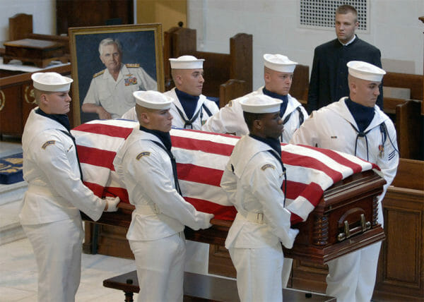 The U.S. flag drapes the casket of retired Navy Vice Adm. James B. Stockdale as it is carried from the U.S. Naval Academy Chapel by the ceremonial guard. Friends, family members and shipmates gathered to attend the funeral service for the former naval aviator, Vietnam prisoner of war, test pilot, academic and Medal of Honor recipient who died July 5, 2005, at the age of 81. He was a member of the U.S. Naval Academy Class of 1947.