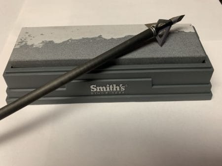 The Smith's 6" Natural Arkansas Sharpening Stone should work fine for putting the edge back on your broadheads. But, some are tougher to sharpen than others.