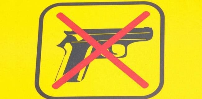 No Guns Yellow Sign NRA-ILA Shutterstock.com sign weapon b620918192
