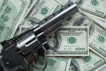 Revolver gun money iStock-1060256694