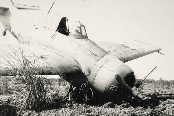 An F4F Grumman Wildcat fighter plane lands on its nose after crash-landing near the runway at Henderson Field on Guadalcanal in 1942. The plane was badly damaged during a dogfight with Japanese Zeros over New Georgia. The pilot was uninjured. F4F Grumman Wildcat fighter plane lands on its nose