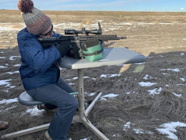 Kate Welch shooting an Anderson Mfg. AM-15, M-LOK, 5.56 off of the Caldwell Stable Table. Notice how long the legs are which adds to the stability.