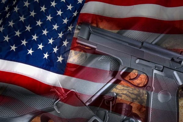 Guns US Flag Lawsuit Weapons United States iStock-SteveAllenPhoto 518957604