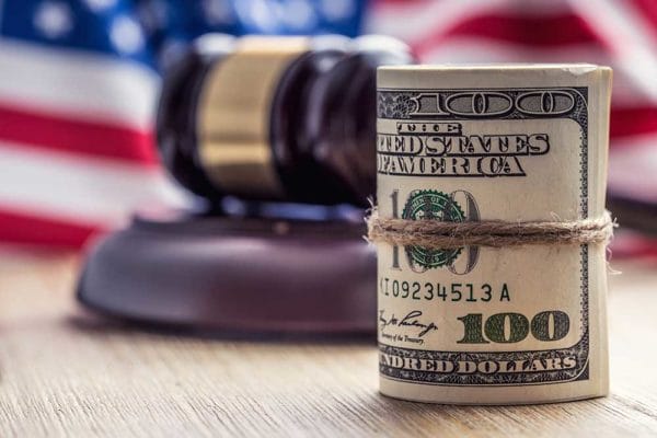 Judge Hammer Gavel Dollars USA Flag Winning iStock-MarianVejcik 638379194