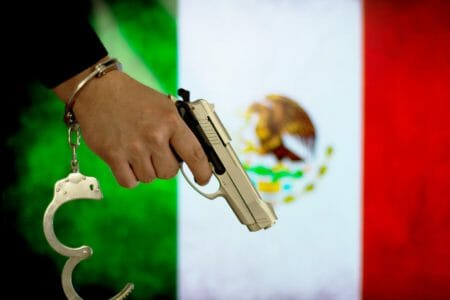 Mexico Flag Criminal Gun iStock-683332844