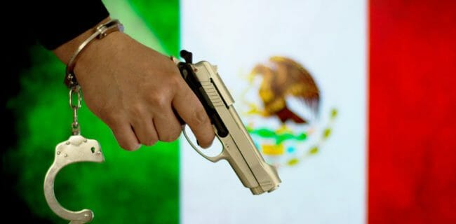 Mexico Flag Criminal Gun iStock-683332844