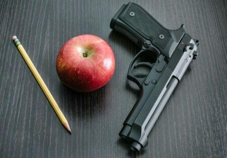 armed school teacher classroom student beretta apple iStock-kenlh 924246940