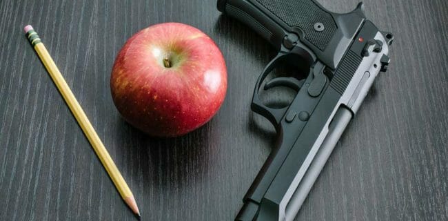 armed school teacher classroom student beretta apple iStock-kenlh 924246940