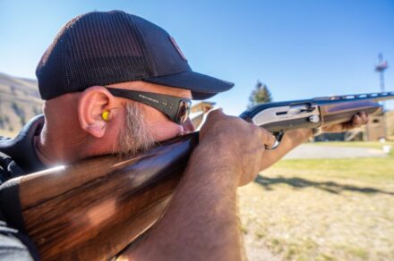 Man aiming rifle and wearing Revision's aluminum eyewear