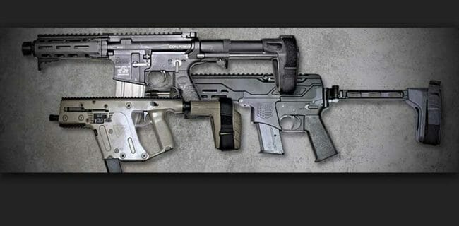 Three stabilizing races attached to machine guns laying on a table Image ATF-gov