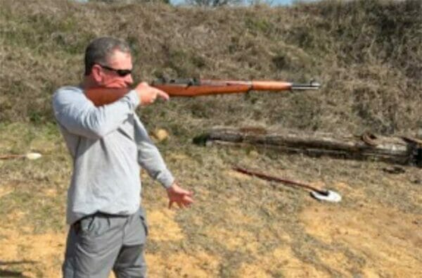 Mark Overstreet shoulders an M1 rifle one-handed