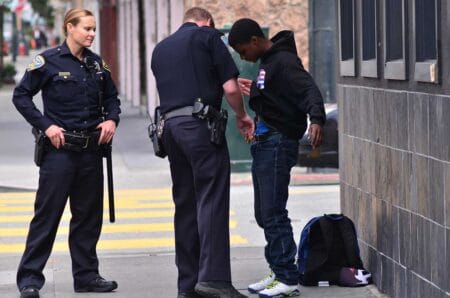 SFPD officers patdown black american man in San Francisco stop and frisk search iStock-chameleonseye 509849326.jpg