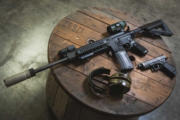 Ar15 rifle with silencer, laser sight and digital night vision monocular, pistol and ear protection iStock-Dmitri Toms 1824328998.jpg