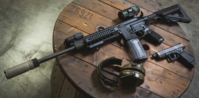 Ar15 rifle with silencer, laser sight and digital night vision monocular, pistol and ear protection iStock-Dmitri Toms 1824328998.jpg