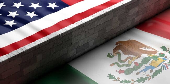 Border wall between US of America and Mexico flags iStock-Rawf8 1125634535