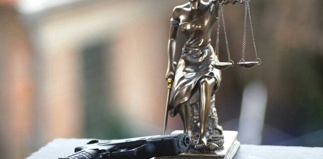 Scales of Justice Gun Laws Court Gavel Judges iStock-Denise Hasse1136158583
