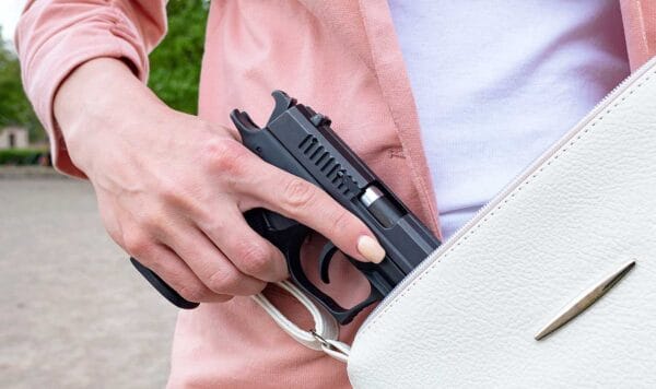 woman concealed carry semi-automatic 9mm pistol permit armed iStock-Evgen_Prozhyrko 1396427553